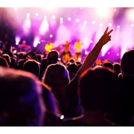 Público em evento com palco iluminado